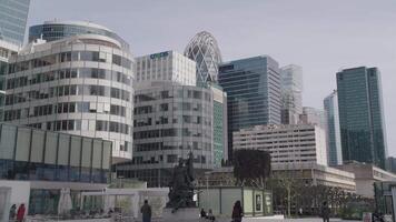 Paris, France - March 20, 2024 - Rows of modern buildings in La Defense stand near the Agam Fountain, creating a striking contrast between contemporary architecture and artistic expression. video