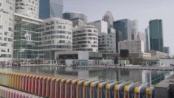 Paris, France - March 20, 2024 - Rows of modern buildings in La Defense stand near the Agam Fountain, creating a striking contrast between contemporary architecture and artistic expression. video