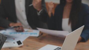 Financial analysts analyze business financial reports on a digital tablet planning investment project during a discussion at a meeting of corporate showing the results of their successful teamwork. video