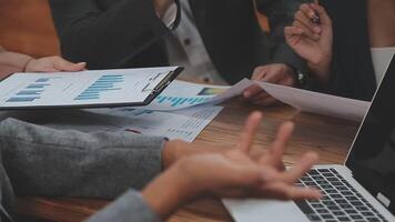 Financial analysts analyze business financial reports on a digital tablet planning investment project during a discussion at a meeting of corporate showing the results of their successful teamwork. video