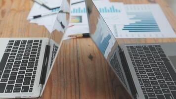 Financial analysts analyze business financial reports on a digital tablet planning investment project during a discussion at a meeting of corporate showing the results of their successful teamwork. video