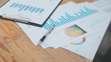 Financial analysts analyze business financial reports on a digital tablet planning investment project during a discussion at a meeting of corporate showing the results of their successful teamwork. video