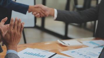 Financial analysts analyze business financial reports on a digital tablet planning investment project during a discussion at a meeting of corporate showing the results of their successful teamwork. video
