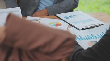 Financial analysts analyze business financial reports on a digital tablet planning investment project during a discussion at a meeting of corporate showing the results of their successful teamwork. video