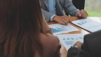 Financial analysts analyze business financial reports on a digital tablet planning investment project during a discussion at a meeting of corporate showing the results of their successful teamwork. video