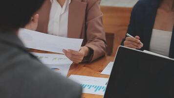 Financial analysts analyze business financial reports on a digital tablet planning investment project during a discussion at a meeting of corporate showing the results of their successful teamwork. video