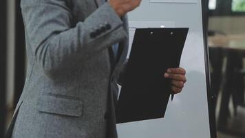 Financial analysts analyze business financial reports on a digital tablet planning investment project during a discussion at a meeting of corporate showing the results of their successful teamwork. video