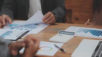 Financial analysts analyze business financial reports on a digital tablet planning investment project during a discussion at a meeting of corporate showing the results of their successful teamwork. video