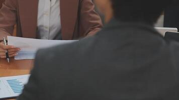 Financial analysts analyze business financial reports on a digital tablet planning investment project during a discussion at a meeting of corporate showing the results of their successful teamwork. video