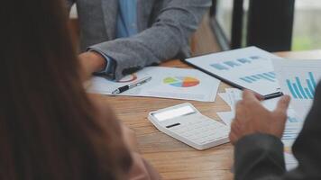 Financial analysts analyze business financial reports on a digital tablet planning investment project during a discussion at a meeting of corporate showing the results of their successful teamwork. video