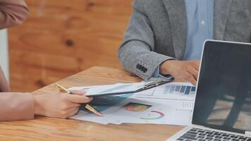Financial analysts analyze business financial reports on a digital tablet planning investment project during a discussion at a meeting of corporate showing the results of their successful teamwork. video