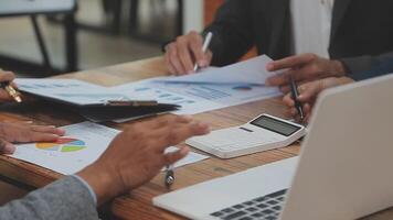 Financial analysts analyze business financial reports on a digital tablet planning investment project during a discussion at a meeting of corporate showing the results of their successful teamwork. video