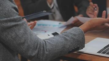 Financial analysts analyze business financial reports on a digital tablet planning investment project during a discussion at a meeting of corporate showing the results of their successful teamwork. video