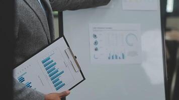 Financial analysts analyze business financial reports on a digital tablet planning investment project during a discussion at a meeting of corporate showing the results of their successful teamwork. video