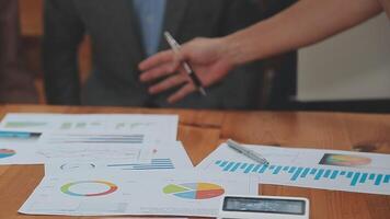 Financial analysts analyze business financial reports on a digital tablet planning investment project during a discussion at a meeting of corporate showing the results of their successful teamwork. video