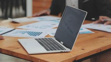 Financial analysts analyze business financial reports on a digital tablet planning investment project during a discussion at a meeting of corporate showing the results of their successful teamwork. video