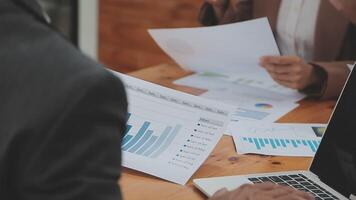 Financial analysts analyze business financial reports on a digital tablet planning investment project during a discussion at a meeting of corporate showing the results of their successful teamwork. video