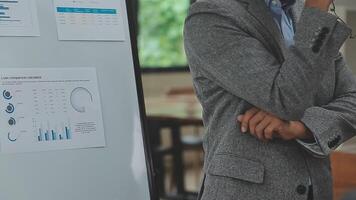 Financial analysts analyze business financial reports on a digital tablet planning investment project during a discussion at a meeting of corporate showing the results of their successful teamwork. video
