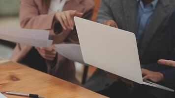 Financial analysts analyze business financial reports on a digital tablet planning investment project during a discussion at a meeting of corporate showing the results of their successful teamwork. video