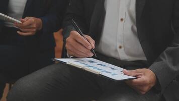 Financial analysts analyze business financial reports on a digital tablet planning investment project during a discussion at a meeting of corporate showing the results of their successful teamwork. video