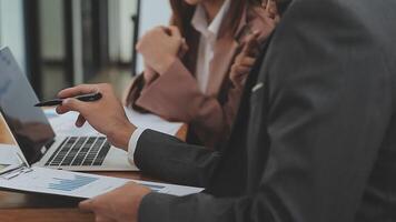 Financial analysts analyze business financial reports on a digital tablet planning investment project during a discussion at a meeting of corporate showing the results of their successful teamwork. video