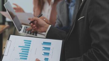 Financial analysts analyze business financial reports on a digital tablet planning investment project during a discussion at a meeting of corporate showing the results of their successful teamwork. video