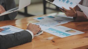 Financial analysts analyze business financial reports on a digital tablet planning investment project during a discussion at a meeting of corporate showing the results of their successful teamwork. video