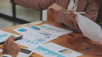 Financial analysts analyze business financial reports on a digital tablet planning investment project during a discussion at a meeting of corporate showing the results of their successful teamwork. video