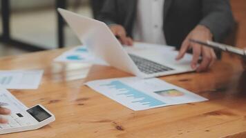 Financial analysts analyze business financial reports on a digital tablet planning investment project during a discussion at a meeting of corporate showing the results of their successful teamwork. video