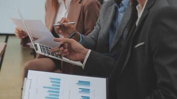 Financial analysts analyze business financial reports on a digital tablet planning investment project during a discussion at a meeting of corporate showing the results of their successful teamwork. video