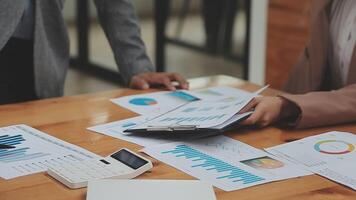 Financial analysts analyze business financial reports on a digital tablet planning investment project during a discussion at a meeting of corporate showing the results of their successful teamwork. video