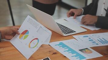 Financial analysts analyze business financial reports on a digital tablet planning investment project during a discussion at a meeting of corporate showing the results of their successful teamwork. video