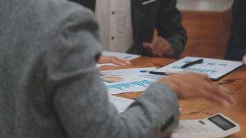 Financial analysts analyze business financial reports on a digital tablet planning investment project during a discussion at a meeting of corporate showing the results of their successful teamwork. video