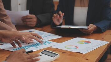Financial analysts analyze business financial reports on a digital tablet planning investment project during a discussion at a meeting of corporate showing the results of their successful teamwork. video