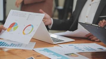 Financial analysts analyze business financial reports on a digital tablet planning investment project during a discussion at a meeting of corporate showing the results of their successful teamwork. video