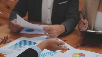 Financial analysts analyze business financial reports on a digital tablet planning investment project during a discussion at a meeting of corporate showing the results of their successful teamwork. video
