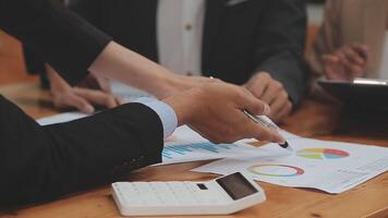 Financial analysts analyze business financial reports on a digital tablet planning investment project during a discussion at a meeting of corporate showing the results of their successful teamwork. video