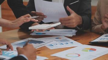 Financial analysts analyze business financial reports on a digital tablet planning investment project during a discussion at a meeting of corporate showing the results of their successful teamwork. video
