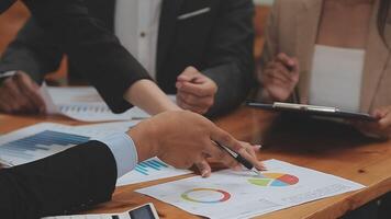 Financial analysts analyze business financial reports on a digital tablet planning investment project during a discussion at a meeting of corporate showing the results of their successful teamwork. video