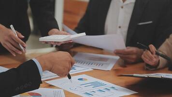 Financial analysts analyze business financial reports on a digital tablet planning investment project during a discussion at a meeting of corporate showing the results of their successful teamwork. video