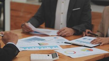 Financial analysts analyze business financial reports on a digital tablet planning investment project during a discussion at a meeting of corporate showing the results of their successful teamwork. video