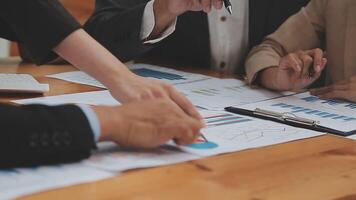 Financial analysts analyze business financial reports on a digital tablet planning investment project during a discussion at a meeting of corporate showing the results of their successful teamwork. video