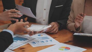 Financial analysts analyze business financial reports on a digital tablet planning investment project during a discussion at a meeting of corporate showing the results of their successful teamwork. video