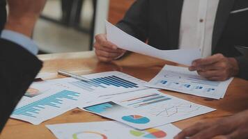 Financial analysts analyze business financial reports on a digital tablet planning investment project during a discussion at a meeting of corporate showing the results of their successful teamwork. video