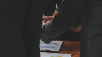 Financial analysts analyze business financial reports on a digital tablet planning investment project during a discussion at a meeting of corporate showing the results of their successful teamwork. video