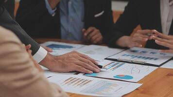 Financial analysts analyze business financial reports on a digital tablet planning investment project during a discussion at a meeting of corporate showing the results of their successful teamwork. video