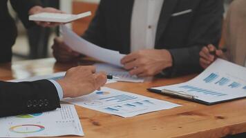 Financial analysts analyze business financial reports on a digital tablet planning investment project during a discussion at a meeting of corporate showing the results of their successful teamwork. video