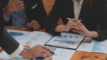 Financial analysts analyze business financial reports on a digital tablet planning investment project during a discussion at a meeting of corporate showing the results of their successful teamwork. video