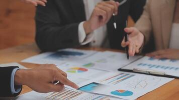 Financial analysts analyze business financial reports on a digital tablet planning investment project during a discussion at a meeting of corporate showing the results of their successful teamwork. video