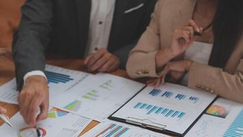 Financial analysts analyze business financial reports on a digital tablet planning investment project during a discussion at a meeting of corporate showing the results of their successful teamwork. video